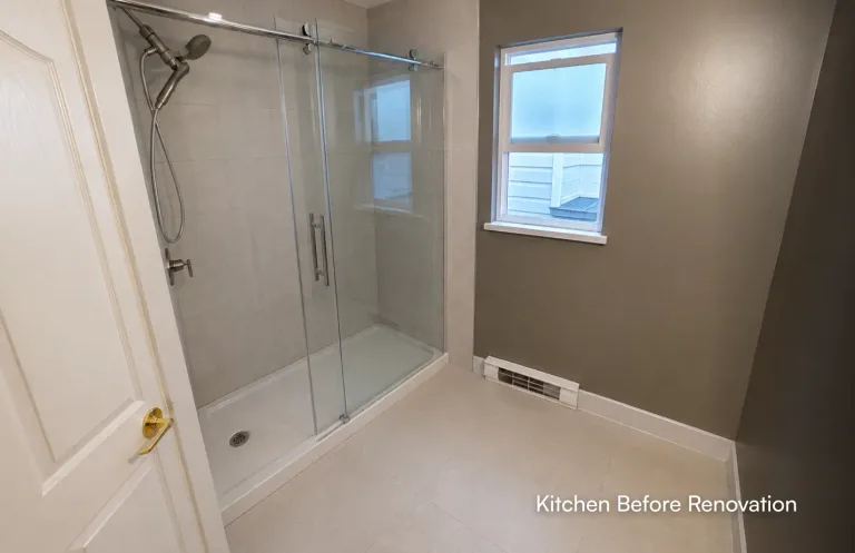 A view inside a newly renovated bathroom focusing on a walk-in shower with large tiled walls, a sliding glass door, and brushed nickel fixtures by Pacific Coast Contracting.