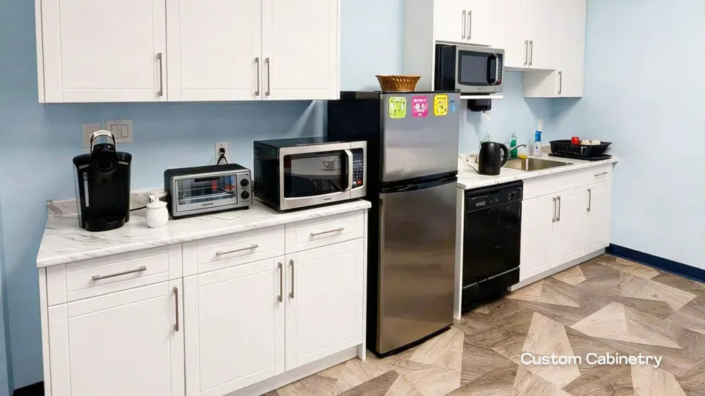 Custom white cabinetry and staff kitchen upgrades completed during a commercial remodel in Port Coquitlam.
