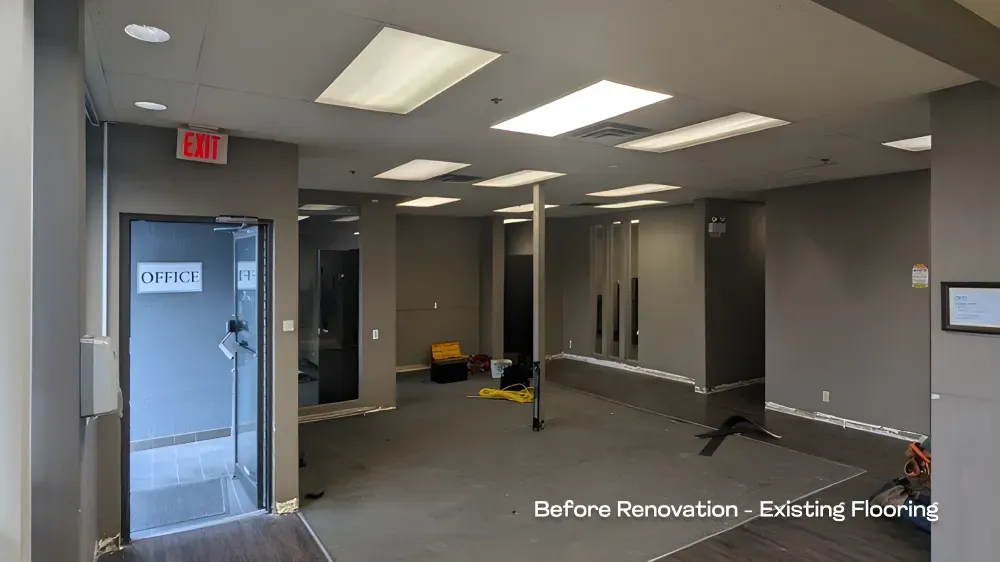 Before photo showing the original dark office layout and existing flooring prior to the remodel.