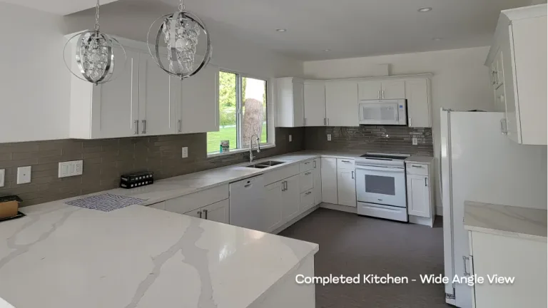 Complete residential kitchen renovation showcasing white shaker cabinetry, quartz countertops, and a grey tile backsplash by PCC. — after