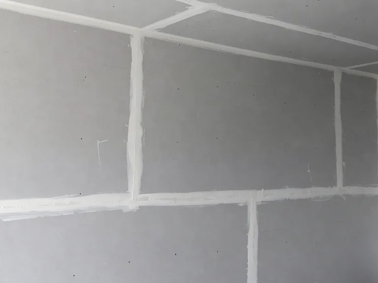 Hung drywall with taped and mudded joints during a condo fire restoration in Chilliwack, BC by PCC Contracting.