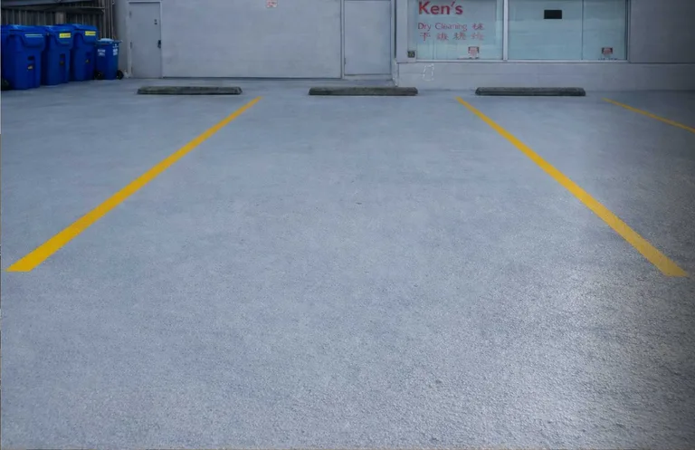 Parking area with a new membrane coating and fresh yellow stall lines after membrane replacement in Vancouver, BC by PCC Contracting. — after