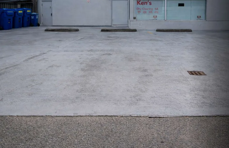 Worn concrete parking area surface before membrane replacement in Vancouver, BC by PCC Contracting. — before