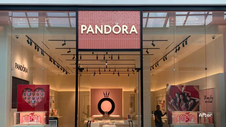 Finished retail jewellery store with a lit storefront sign, track lighting and product displays after a store renovation in Vancouver, BC, by PCC Contracting. β after