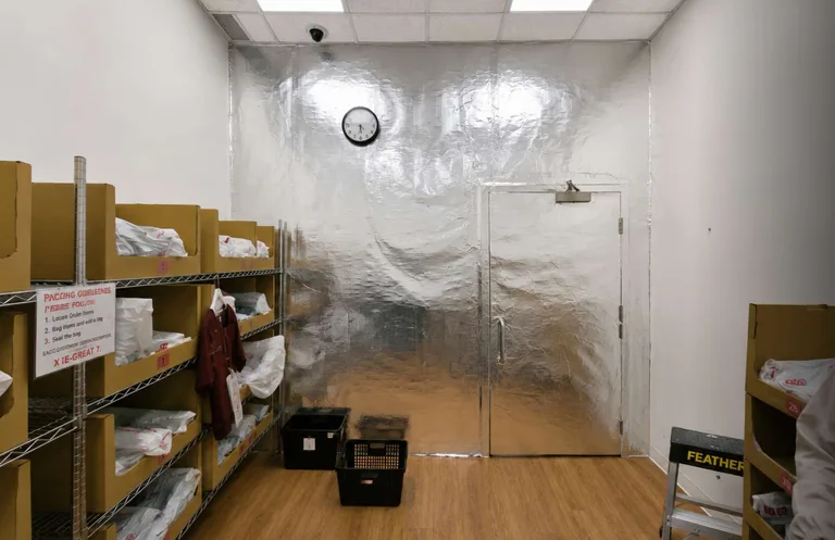 Retail back room with foil-lined RFID shielding covering the wall and door after installation in Coquitlam, BC by PCC Contracting. — after